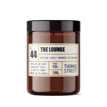 The lounge candle - a vase of sunny flowers on the mantel. 200g.