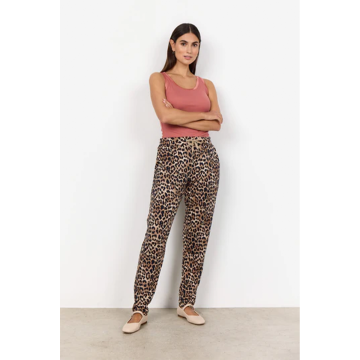 sand trousers on model from the front paired with pink vest top.